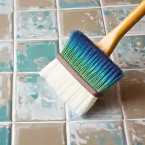 a brush with a tile is used on a tiled floor, in the dark turquoise and light white style