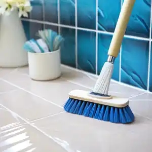 a blue broom is on the tile cleaning the tile, in the style of the combination of natural and artificial elements